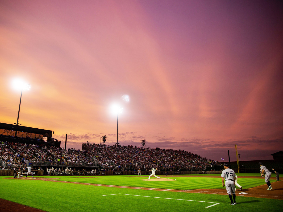 Orange hues paint the sky during the game between the New York Yankees and the Chicago White Sox near the Field of Dreams movie site outside of Dyersville, Thursday, Aug. 12, 2021.